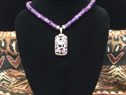 Amethyst necklace with a rectangular shaped pendant for sale.